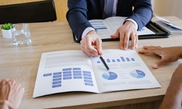 advisor with couple looking at graphs